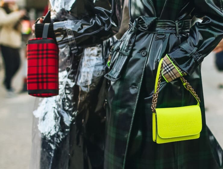 a pair of women wearing raincoats. London Fashion Week Spring/Summer 2025