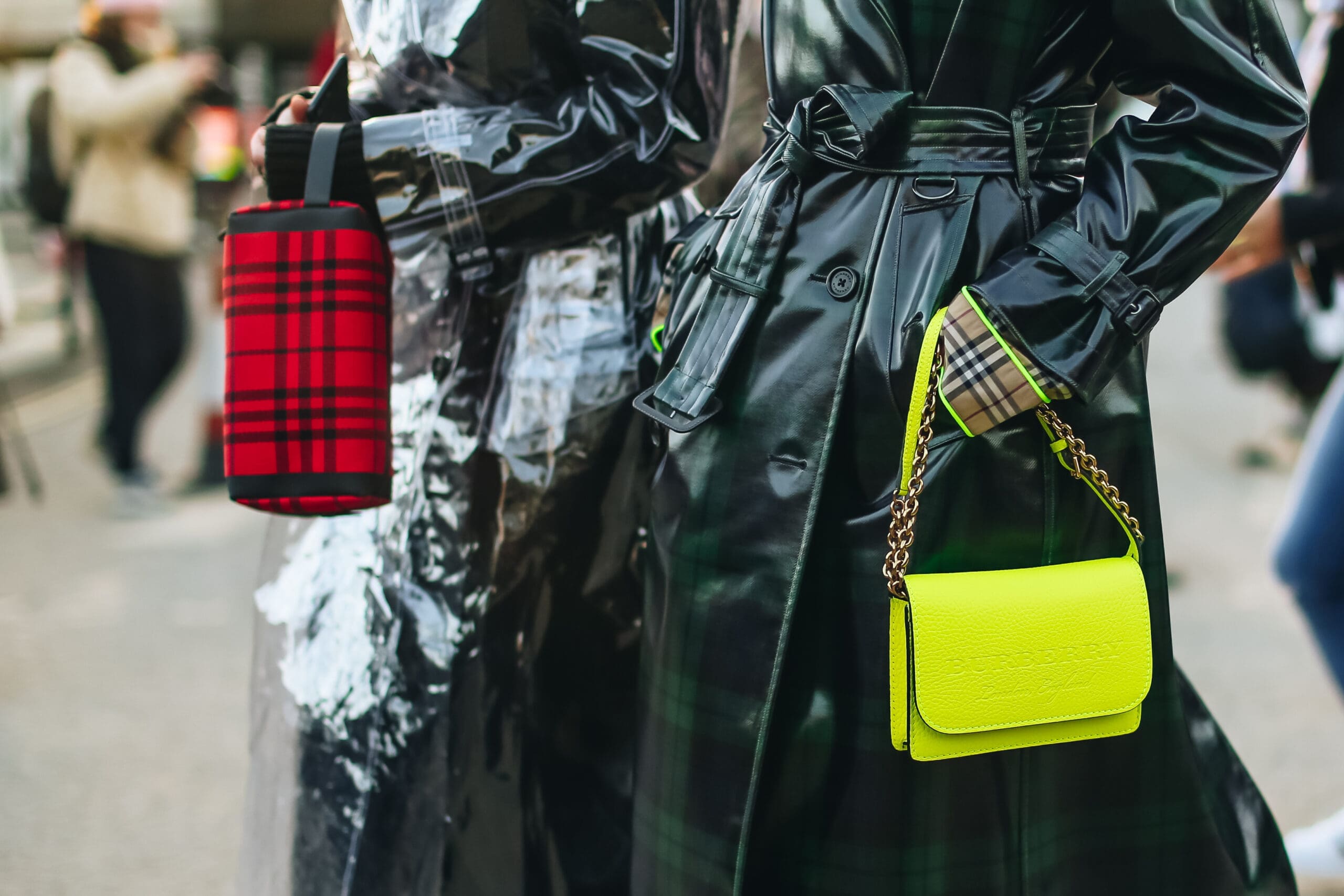 a pair of women wearing raincoats. London Fashion Week Spring/Summer 2025